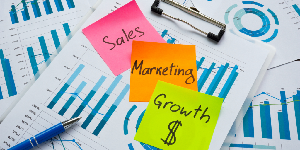 Sales marketing and growth on a clipboard.