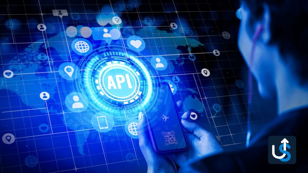 A person interacts with a digital interface displaying the term "API" surrounded by various icons, suggesting connectivity and data exchange. A world map is visible in the background.