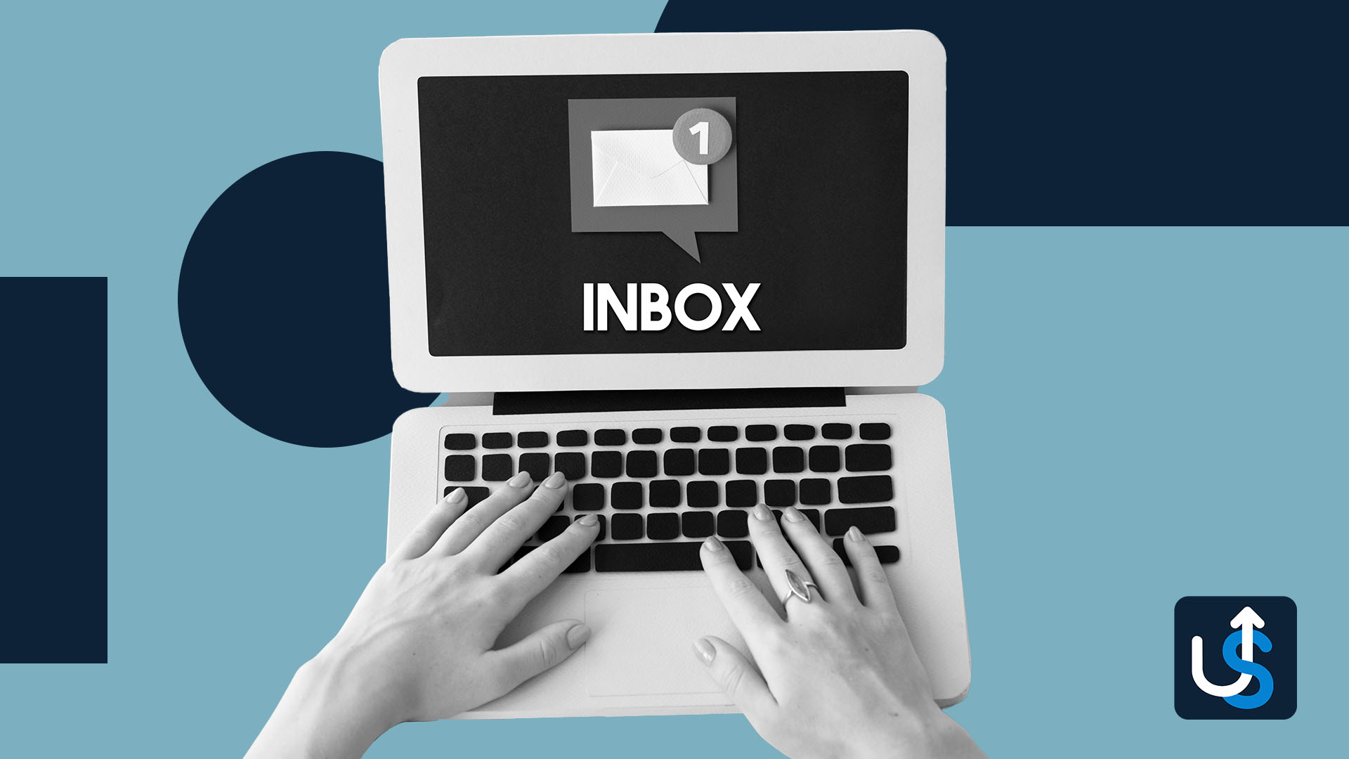Hands typing on a laptop with an "INBOX" notification on the screen indicating one new message. U-shaped arrow icon in the bottom right corner.