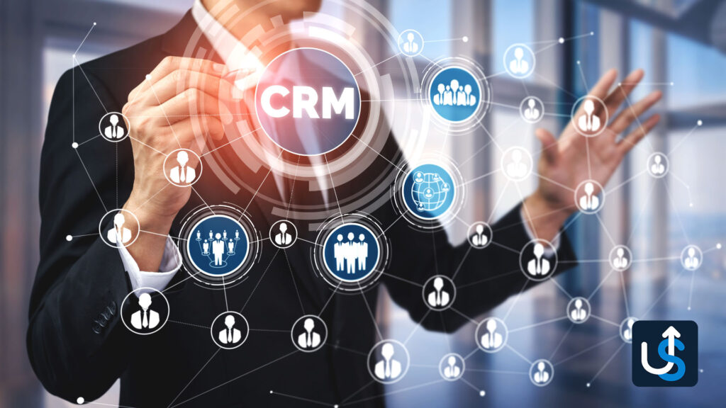 A person interacts with a transparent digital CRM interface displaying interconnected icons representing people and various business-related symbols.