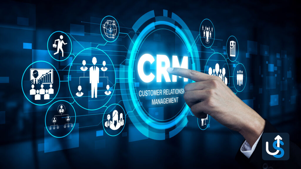 A hand pointing at a digital display reading "CRM Customer Relations Management," surrounded by various icons illustrating different business functions.