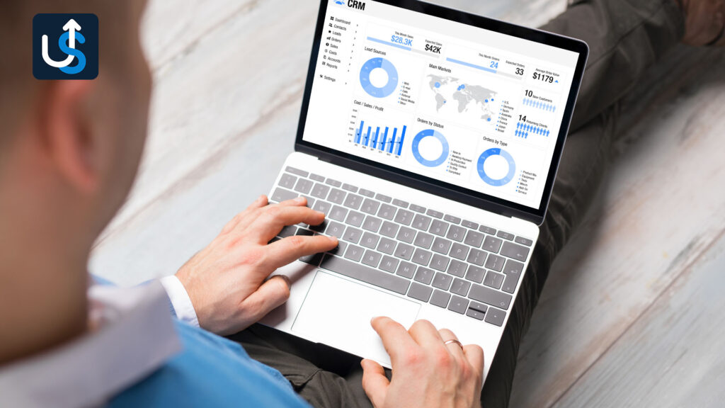 Person looking at data analytics dashboard on a laptop screen.