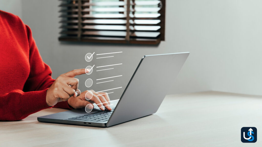 Person in a red sweater using a laptop with a virtual checklist interface.